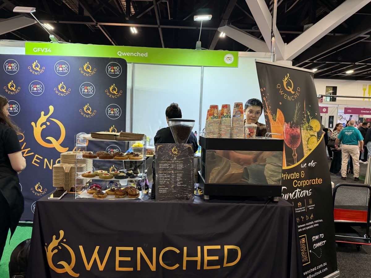 The Qwenched stand with pastries and drinks on display
