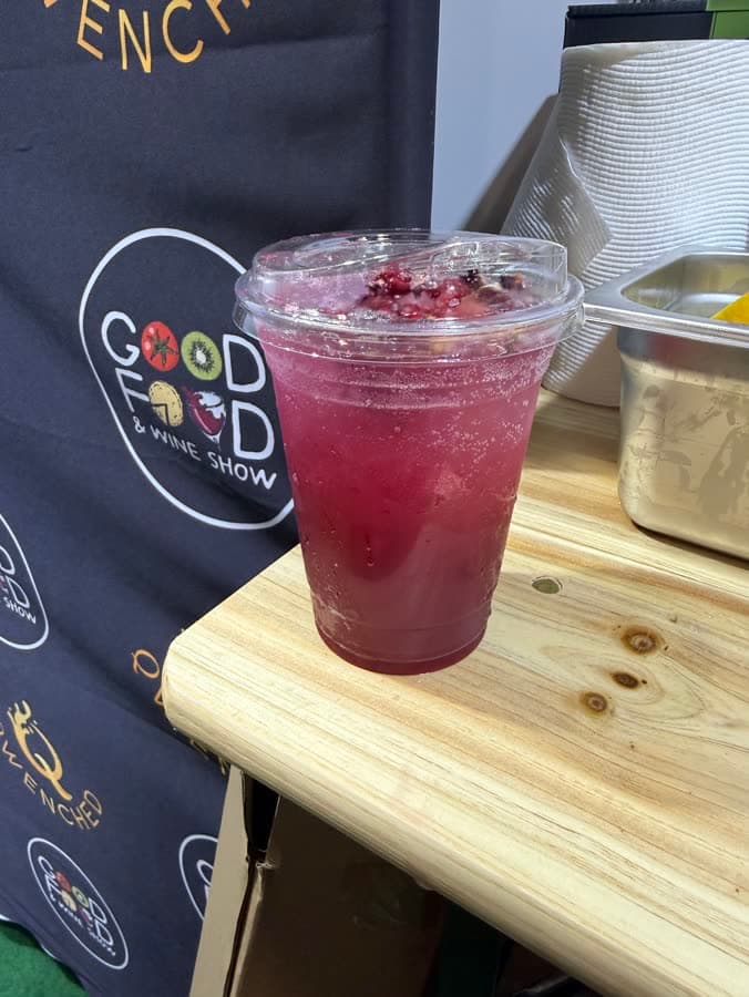 Deep berry mocktail against the Qwenched backdrop